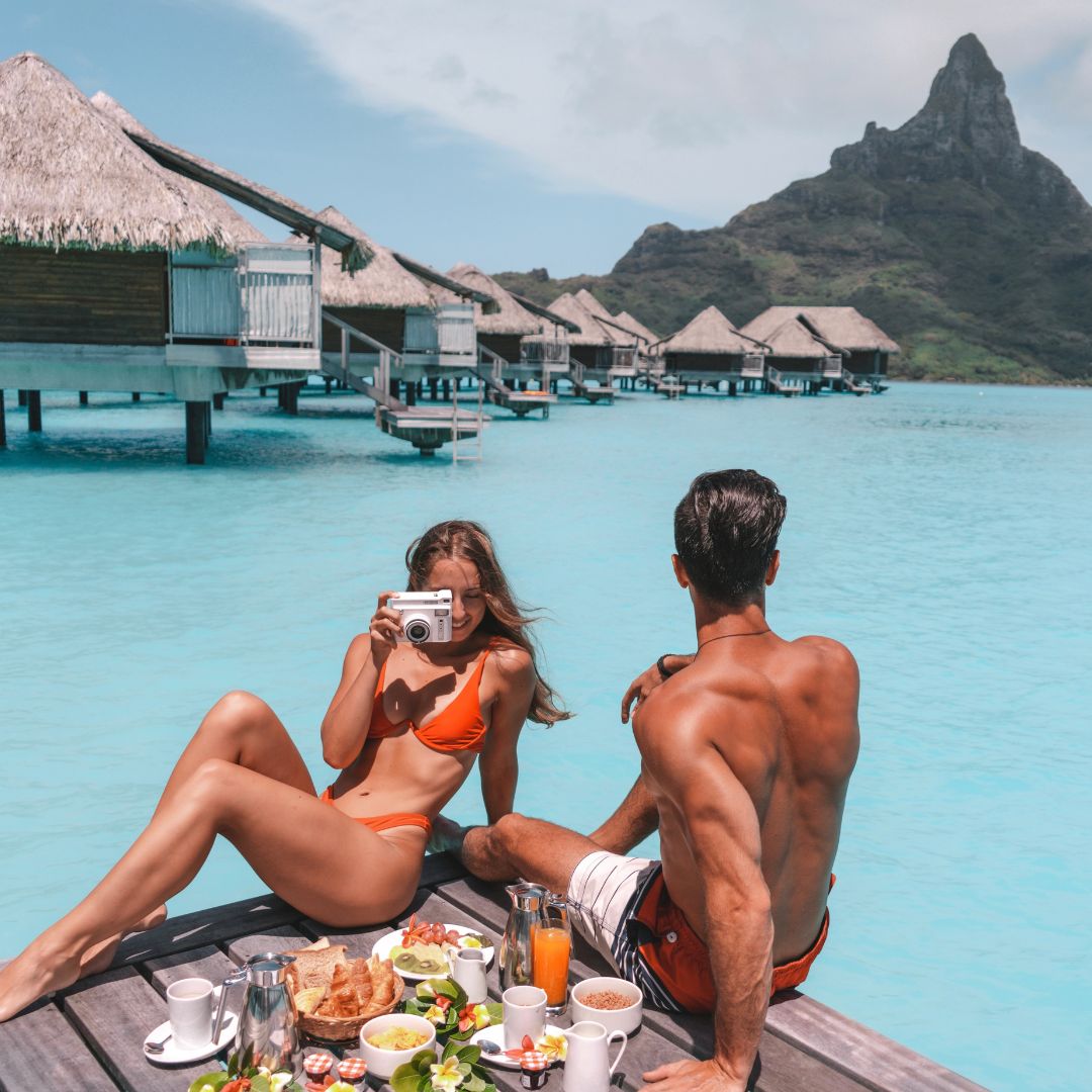 Be like this happy couple traveling and enjoying a meal by the water with their Adventure Challenge camera!